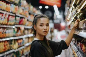Woman in supermarket featuring consumer centricity